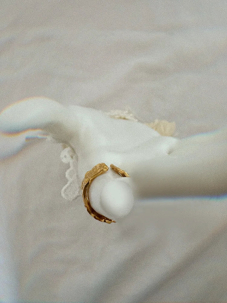 Fairies Whisper Venus de Milo Ring front view, wide imperfect gold ring wrapping finger, thickness about half a coin