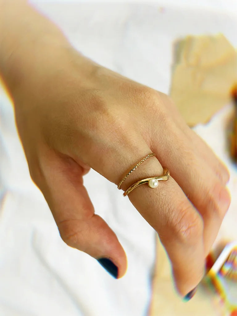 Fairies Whisper slim gold pearl ring worn on finger, elegant minimalist jewelry